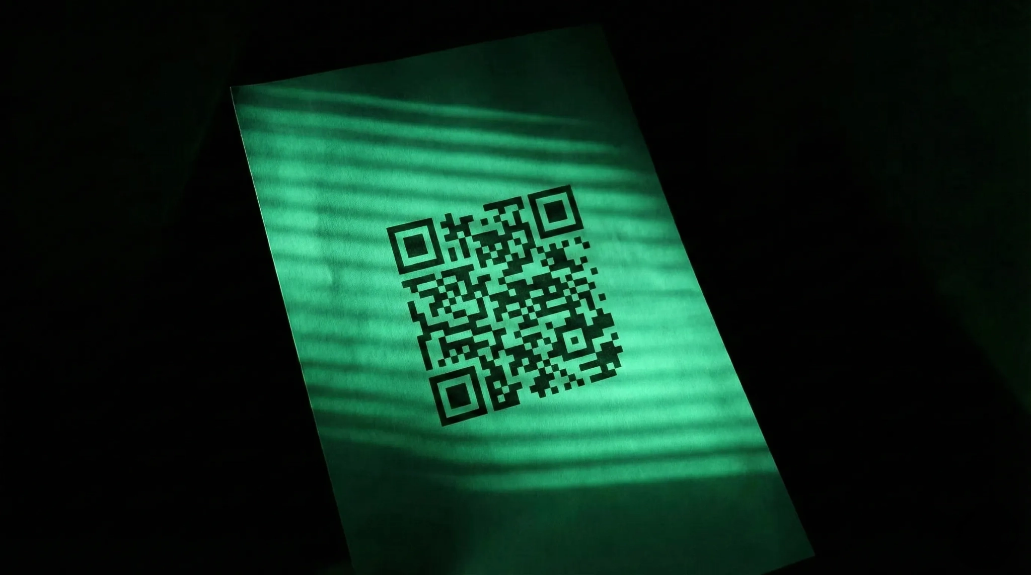 QR code displayed on green offline signage used for tracking offline signage.