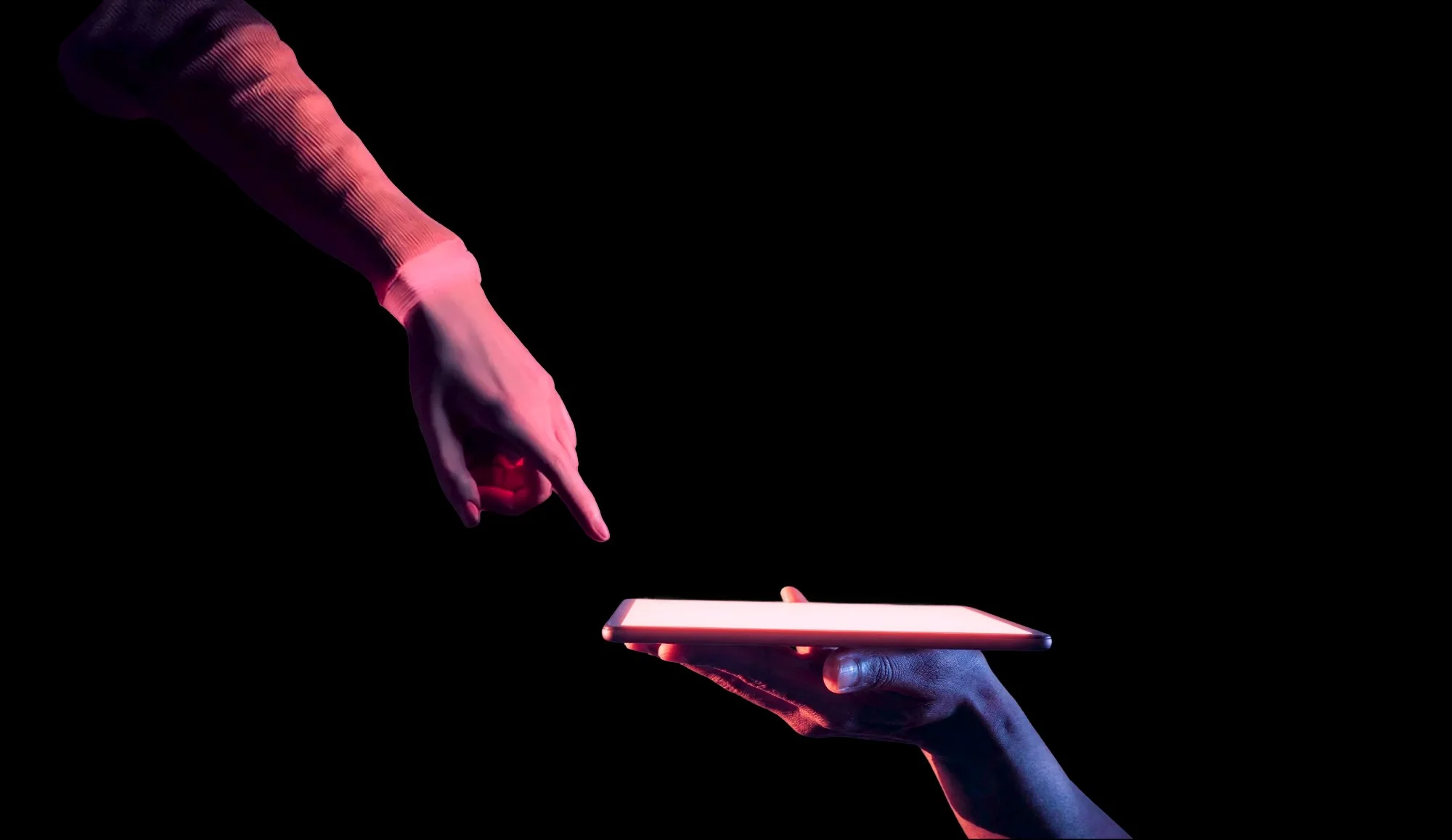Two hands reaching toward each other against a black background, one pointing finger extending down, the other holding a glowing tablet from below, evoking Michelangelo's Creation of Adam in a modern digital context of automatic attribution.