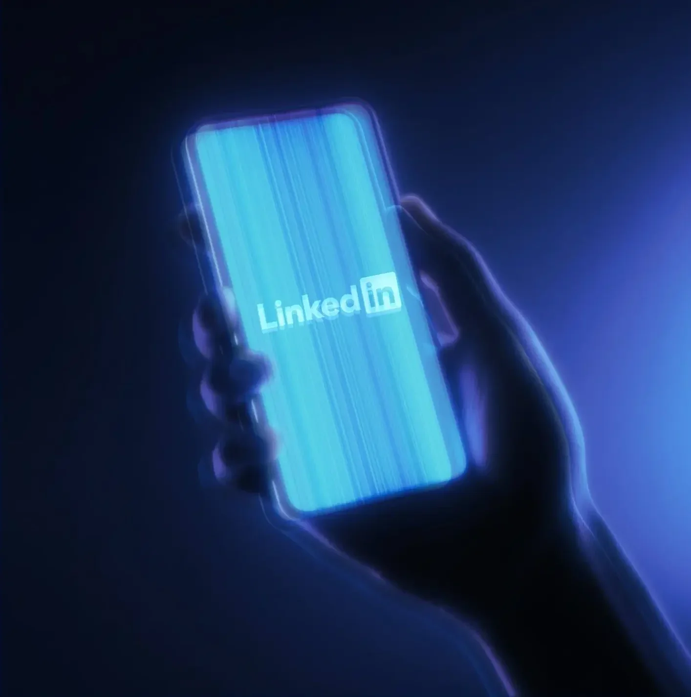 Hand holding smartphone displaying glowing cyan LinkedIn logo on screen with vertical light streaks against dark blue background creating futuristic digital effect, signifying the difficulty with Linkedin campaign tracking.